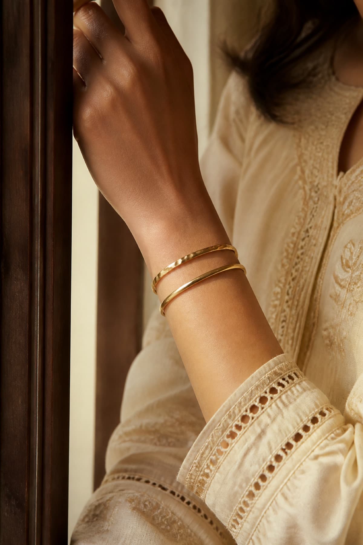 Gold-tone bangles on the arm